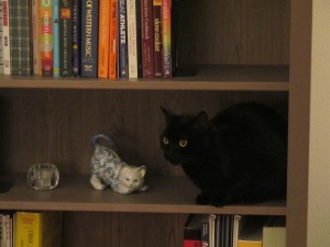Interestingly, she's right next to a cat figurine...